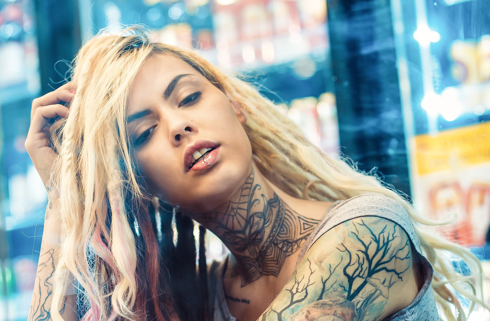Blond girl with many tattoos wearing tank top
