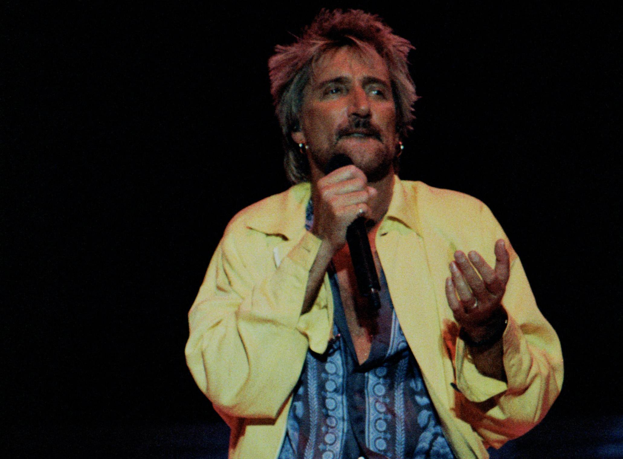 Singer Rod Stewart performs on stage at The Gorge Amphitheater in yellow jacket