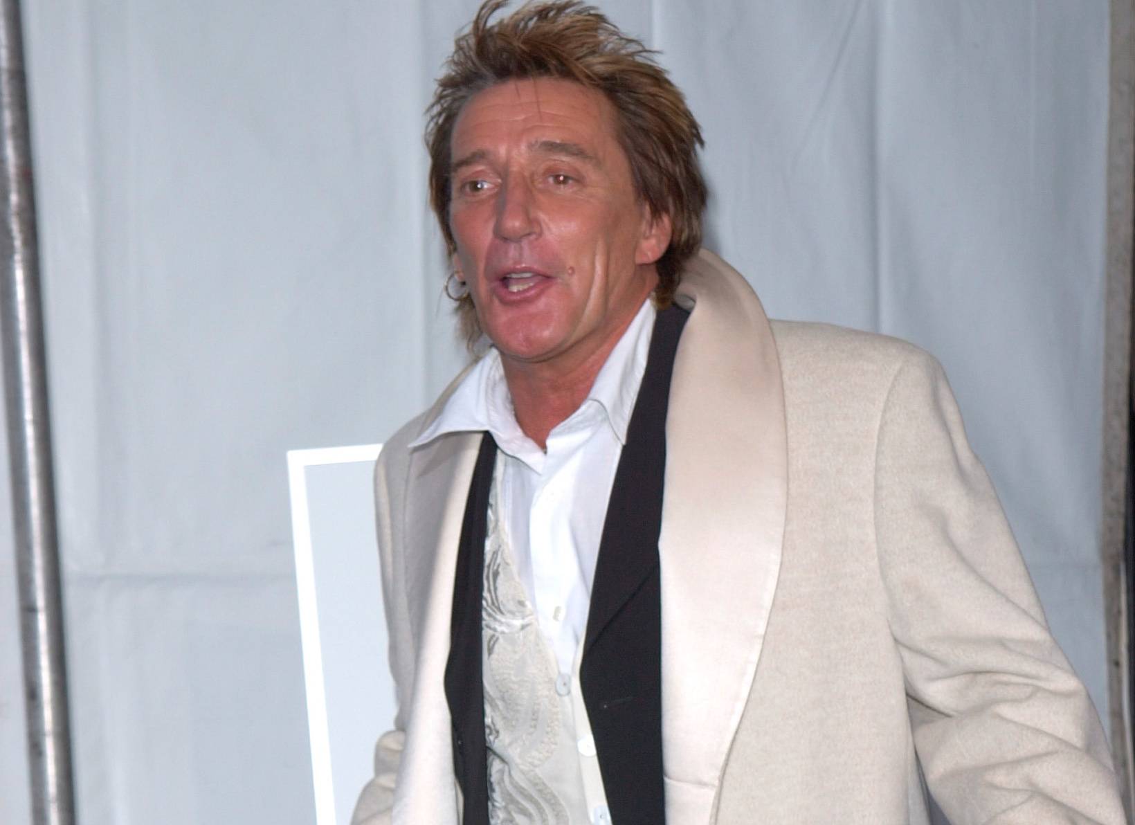 ROD STEWART in white coat and black suit at an formal event