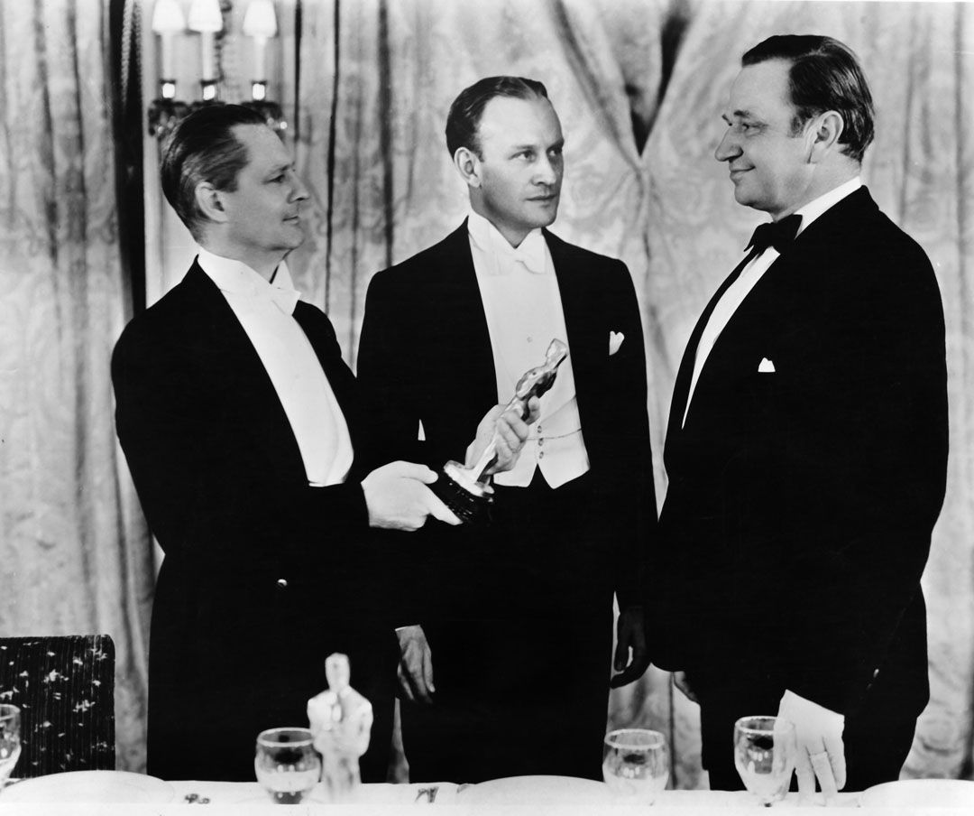 Wallace Beery, with Lionel Barrymore and Master of Ceremonies Conrad Nagel at Academy Awards