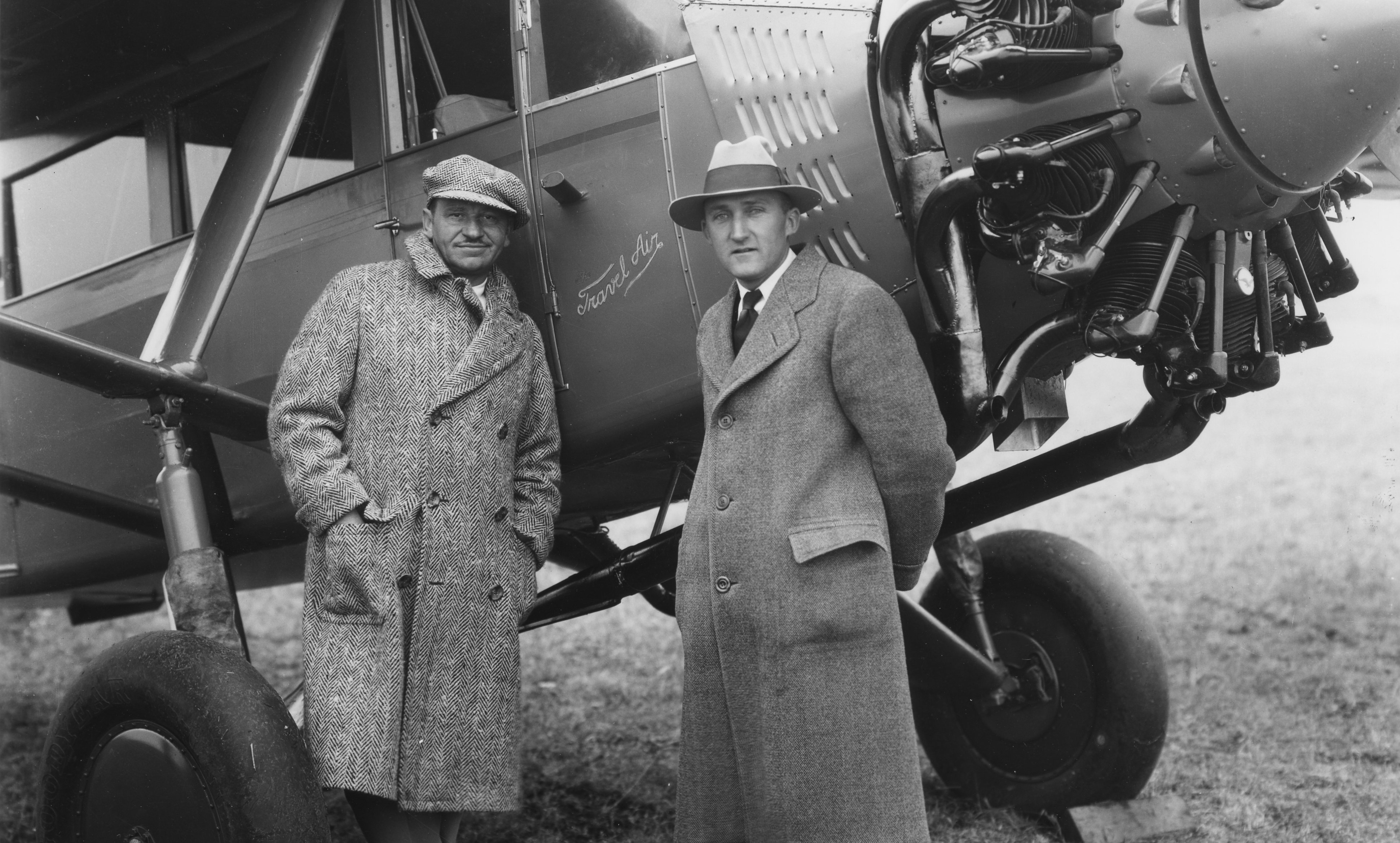 American actor Wallace Beery (1885 - 1949) (left) and aviator & Beech Aircraft Corporation founder Walter H Beech (1891 - 1950) pose beside a closed-cabin, Travel Air Model 6000 high-wing monoplane, Wichita, Kansas, December 1928.