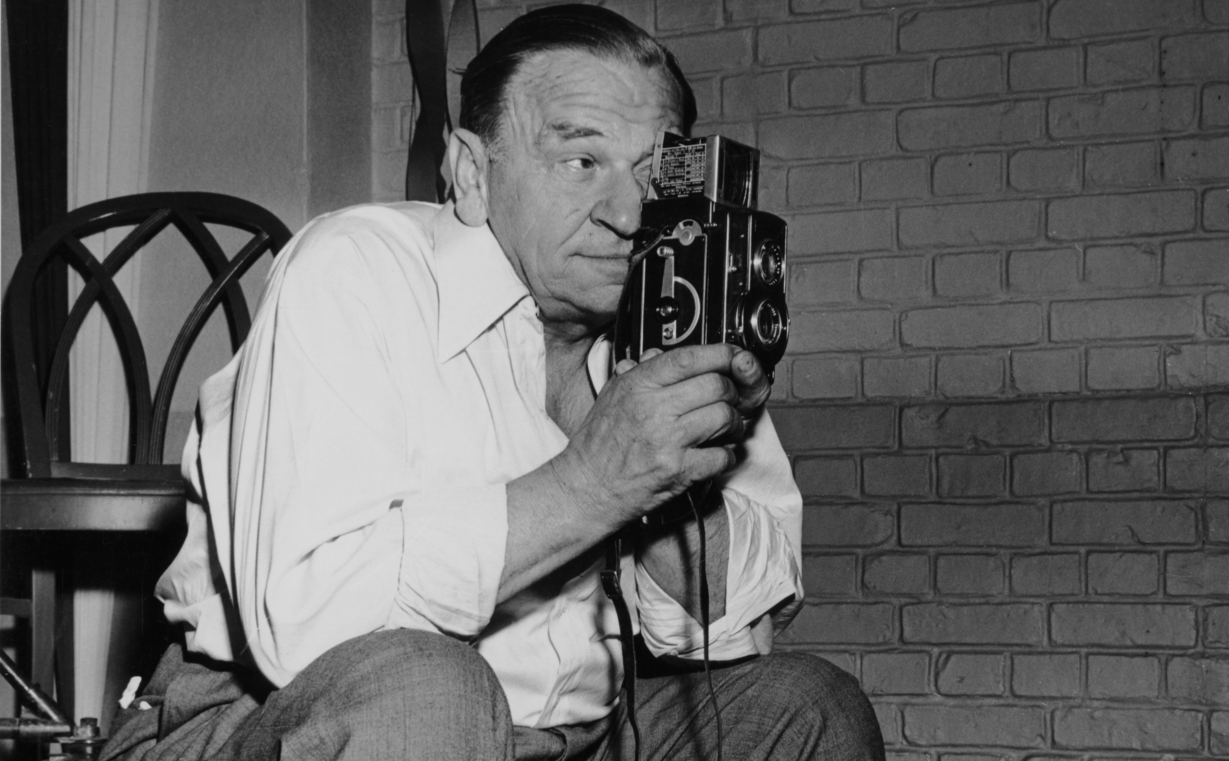 American actor Wallace Beery (1885 - 1949) takes film footage on the set of the MGM film 'A Date with Judy', in which he stars, 1948.
