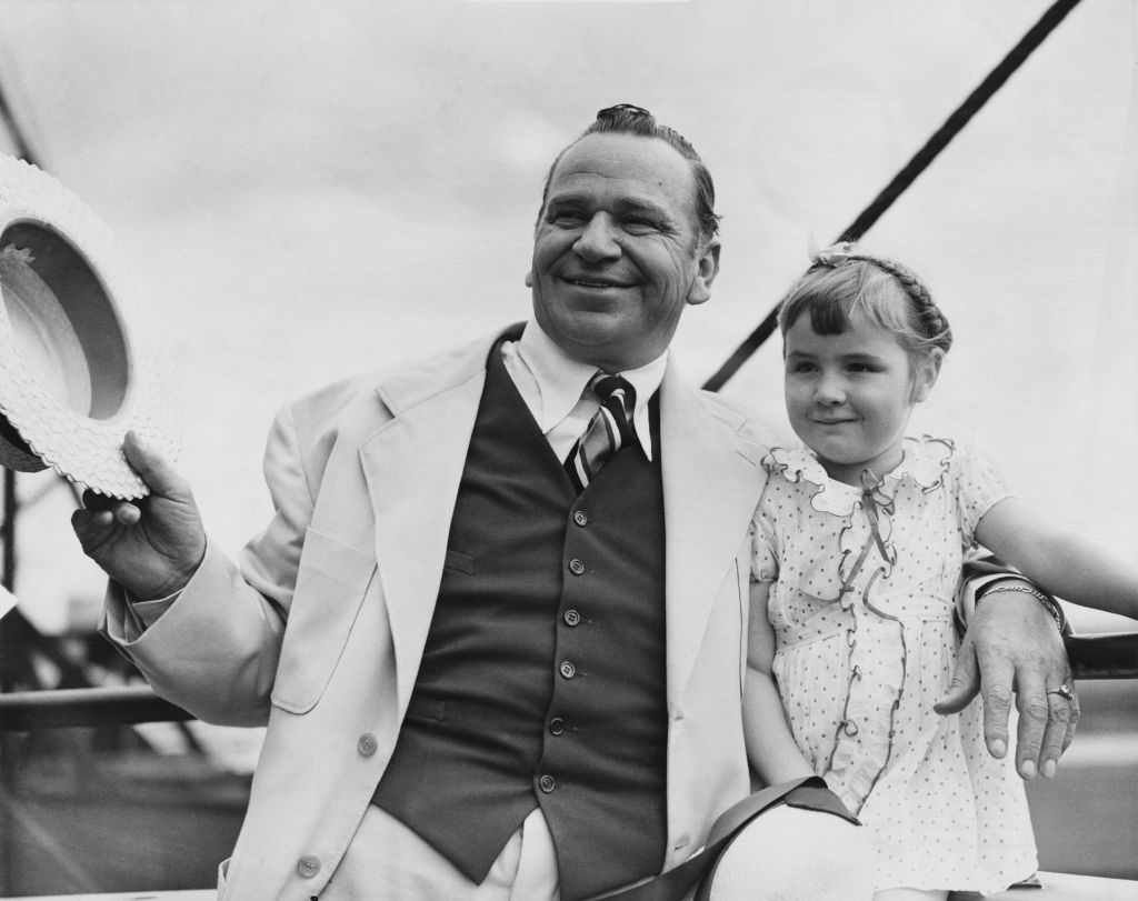 American actor Wallace Beery (1885 - 1949) with his daughter Carol Ann Beery, as they arrive at Southampton from New York aboard the Cunard White Star liner 'Majestic', 15th August 1935.