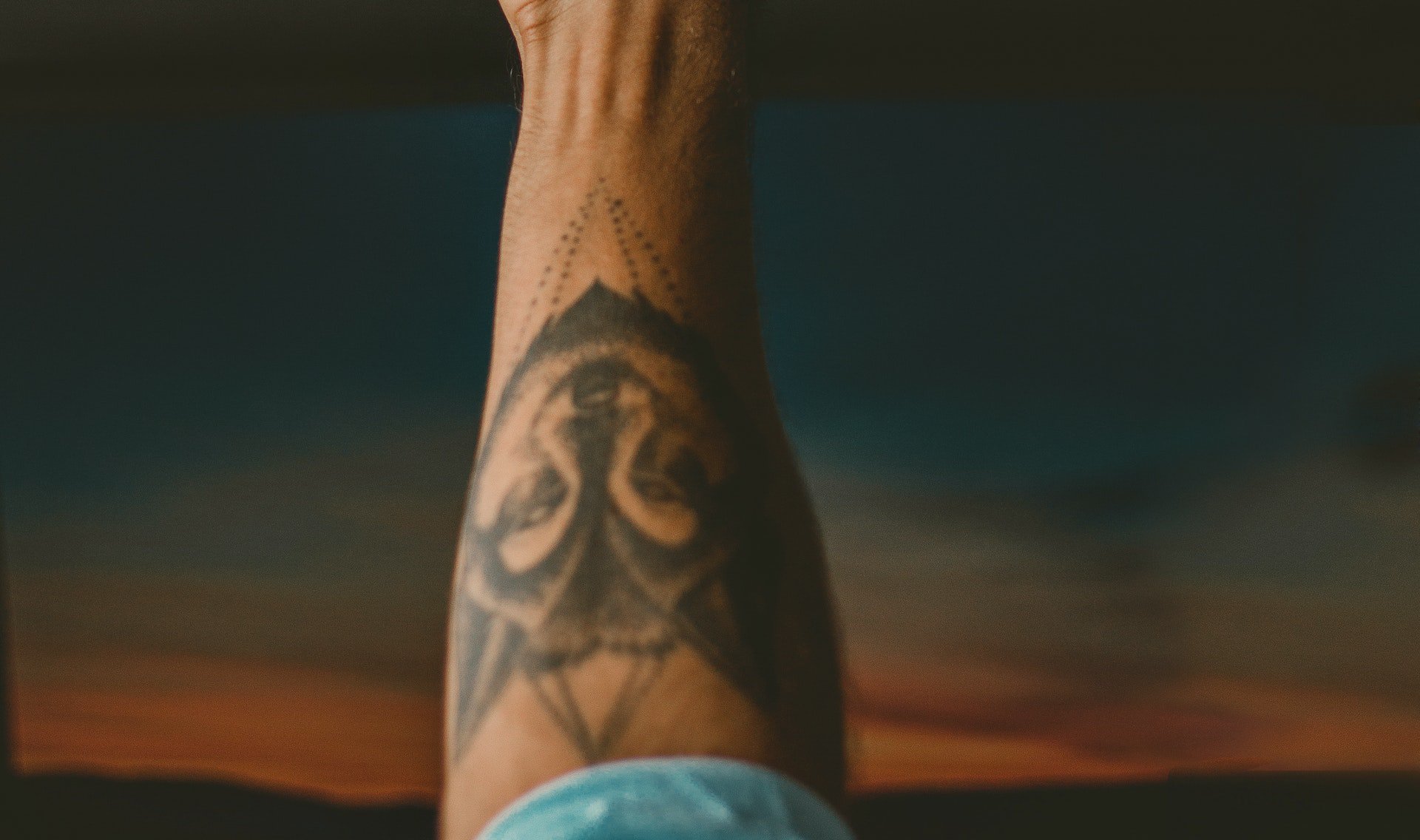 Person Showing Right Hand With Black Tattoo