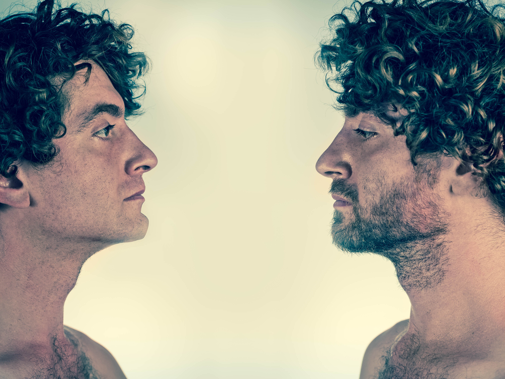 Half shaved man looking at himself