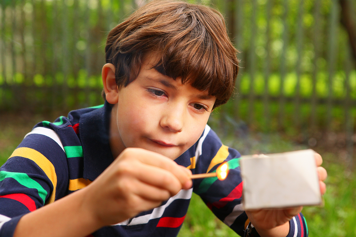 Young Boy Striking A Match