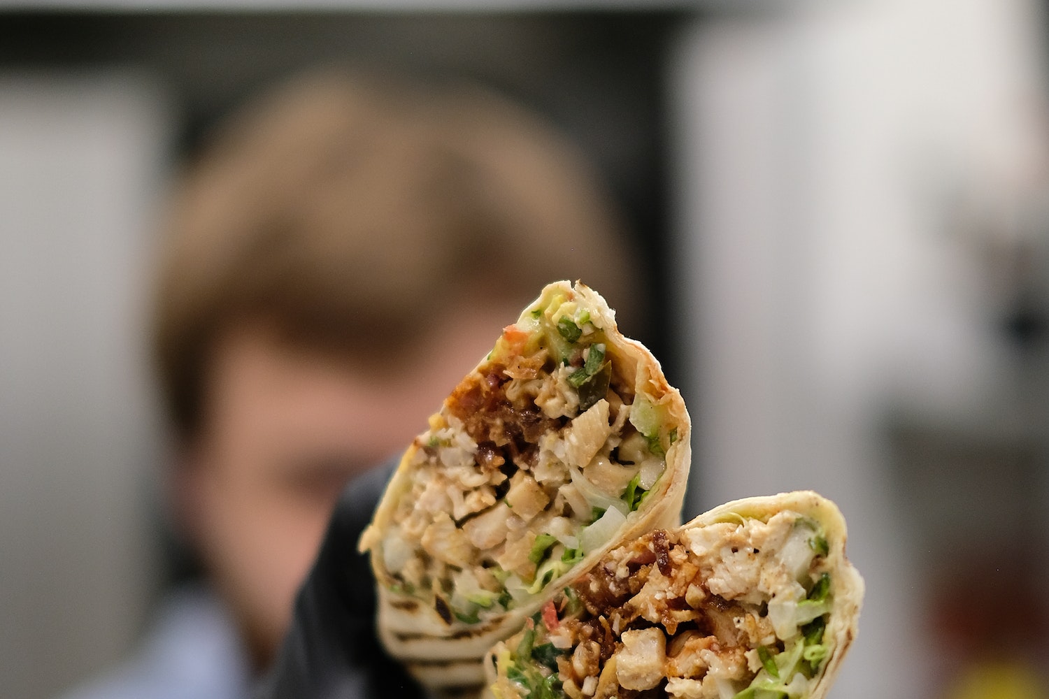 Person Holding Burritos
