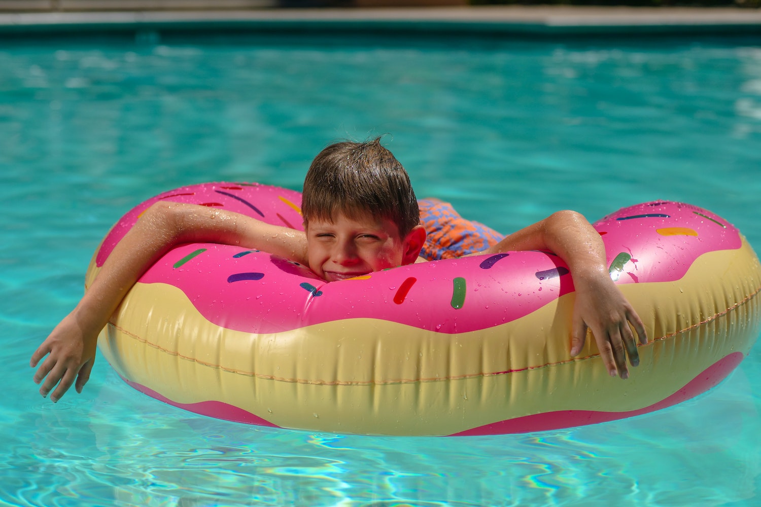 Kid Lying on a Floater Floating in a Poolho