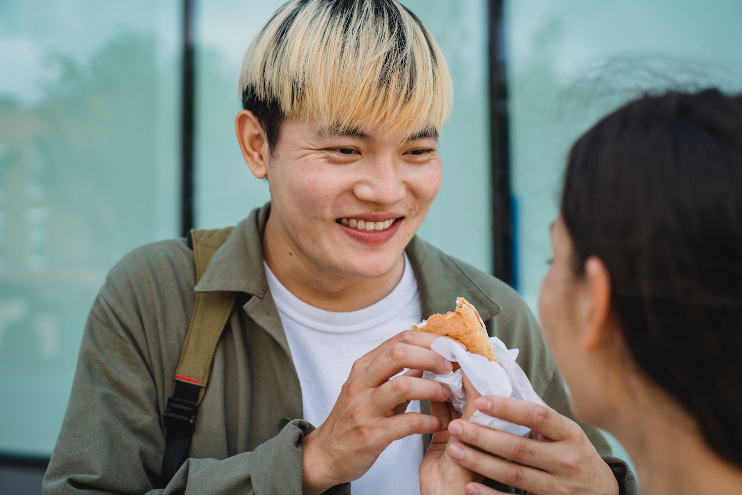 Asian Man Holding A Hot Dog