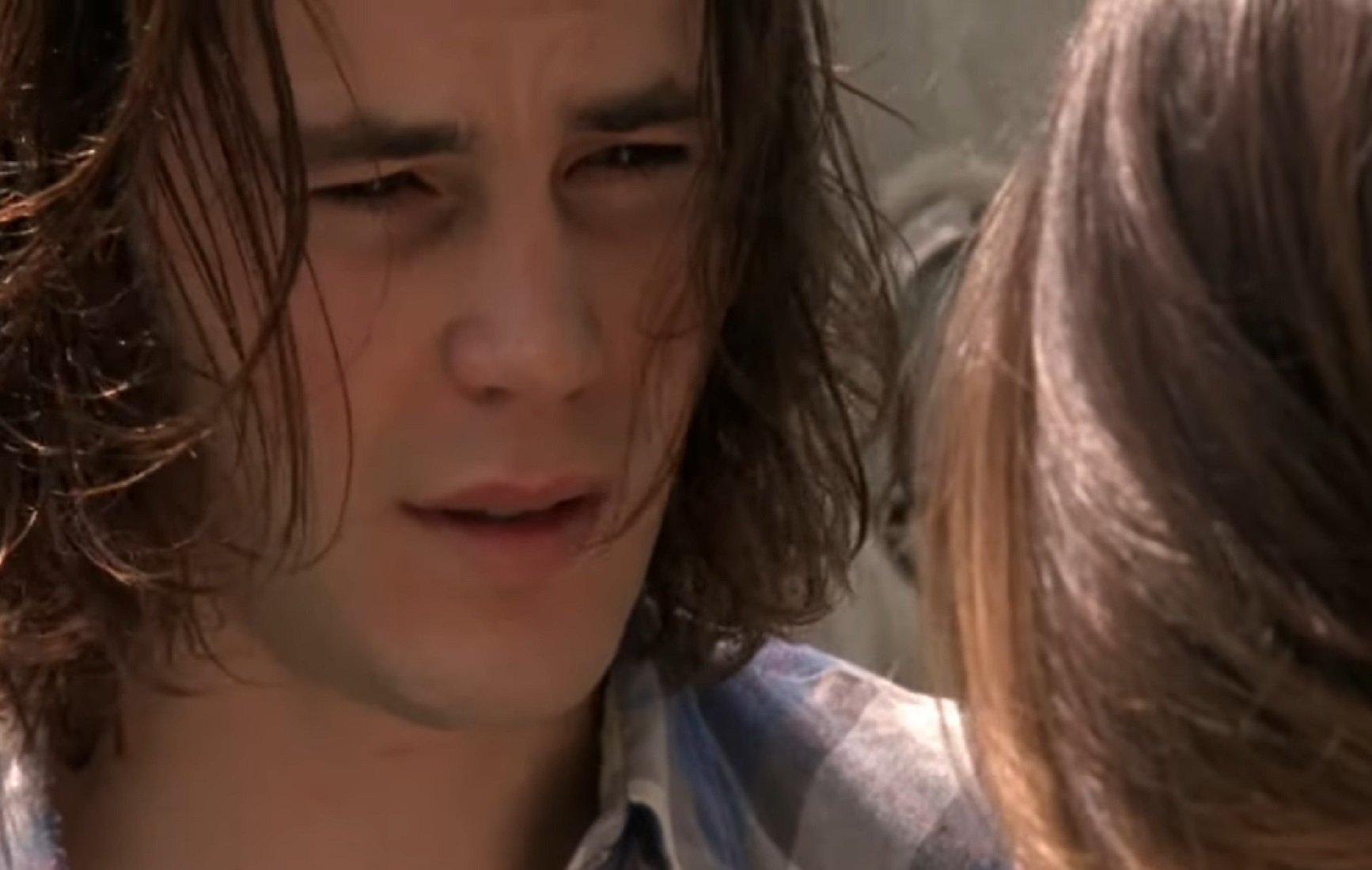 Taylor Kitsch is looking and talking to another person - from Friday Night Lights (2006-11)