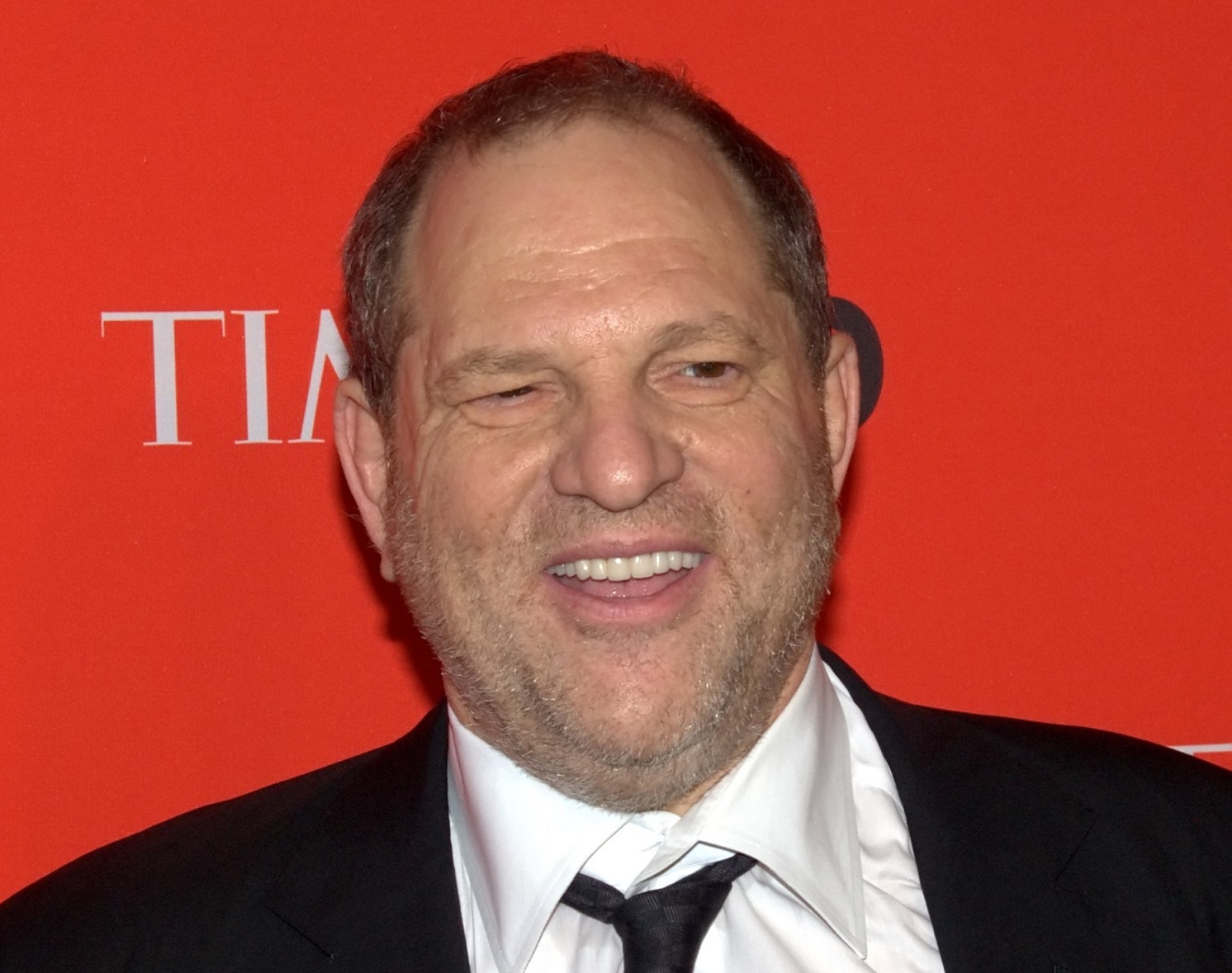 Harvey Weinstein is looking at side and smiling - 2010