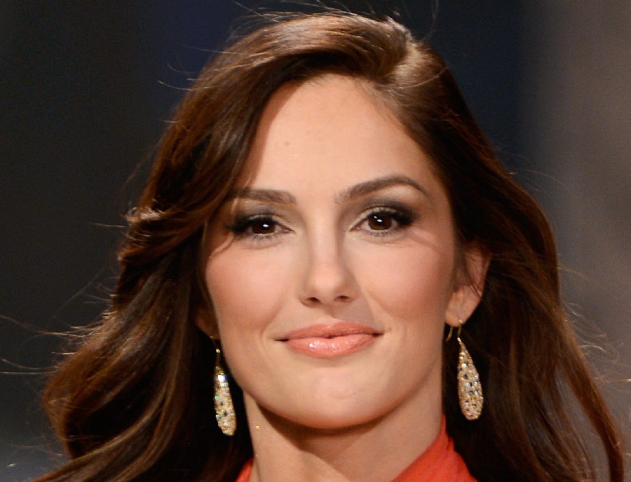 Minka Kelly wearing red dress and earrings is looking at front and smiling - 2013