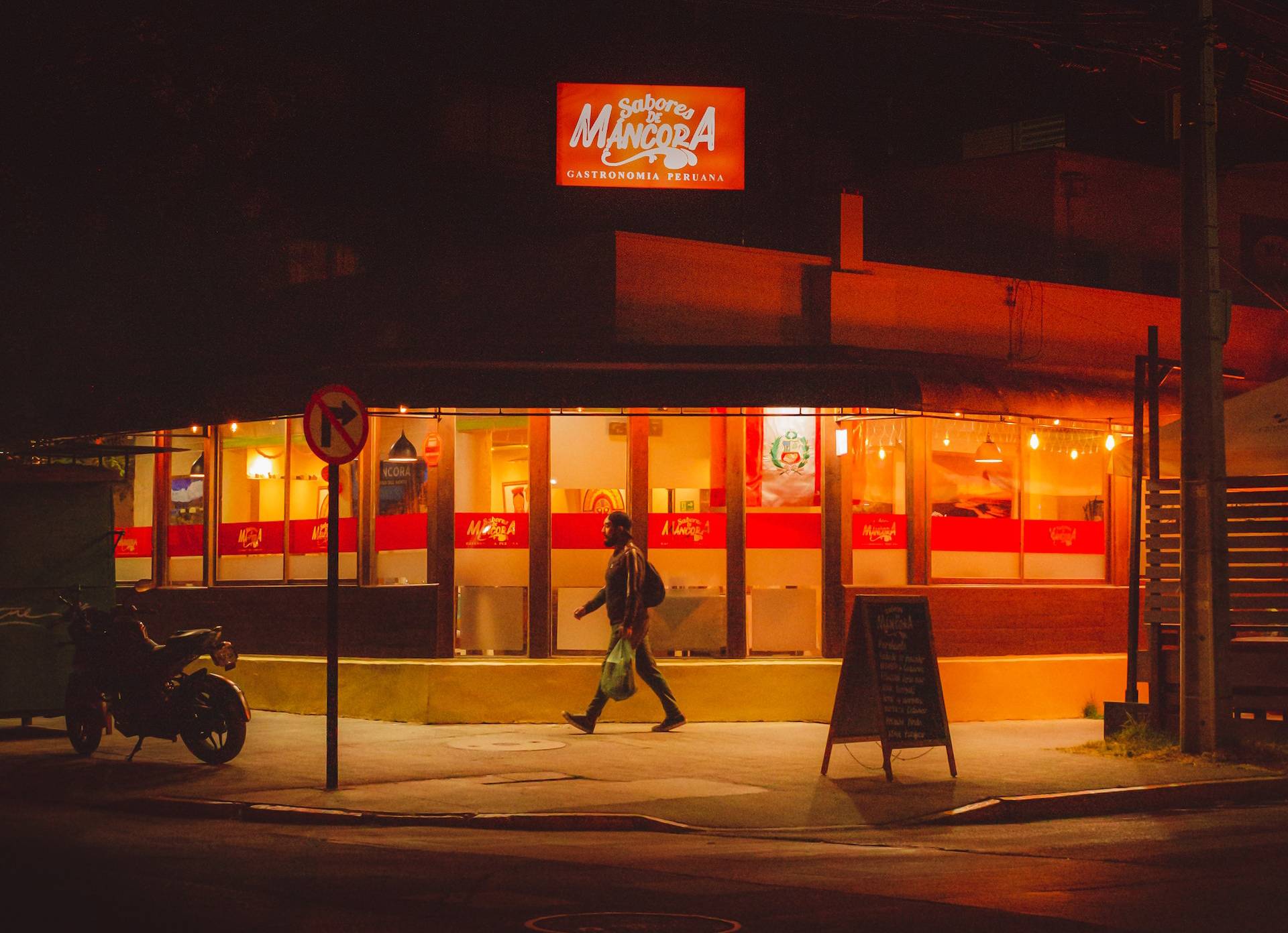 man walking on street at night
