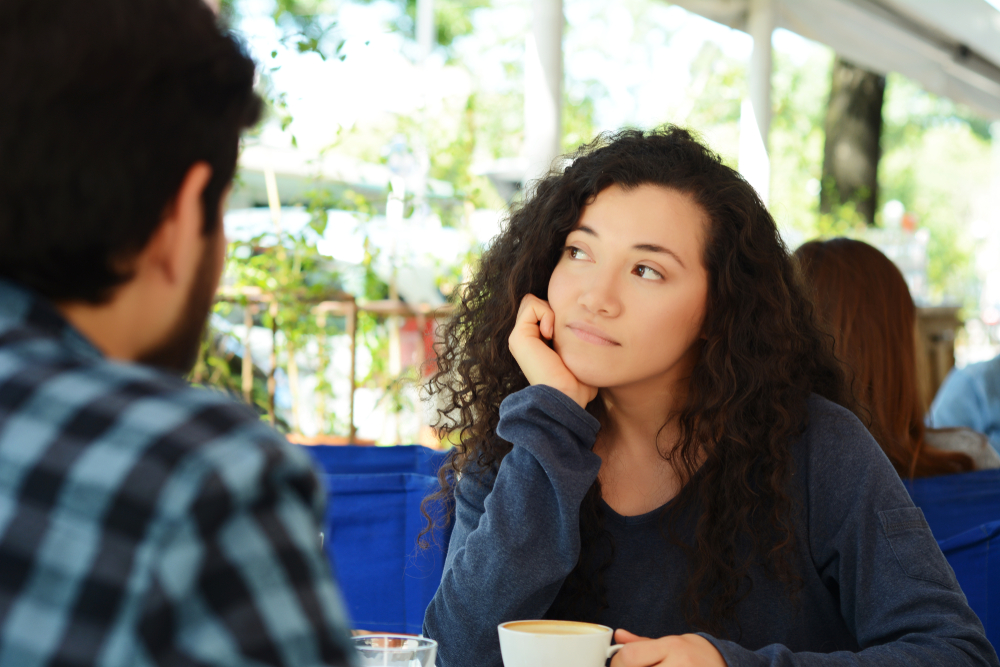Young beautiful woman bored at a date in coffee shop