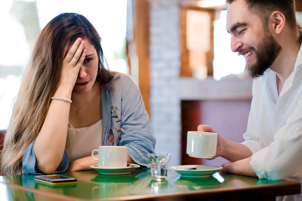 Woman getting bored at a date at a coffee shop