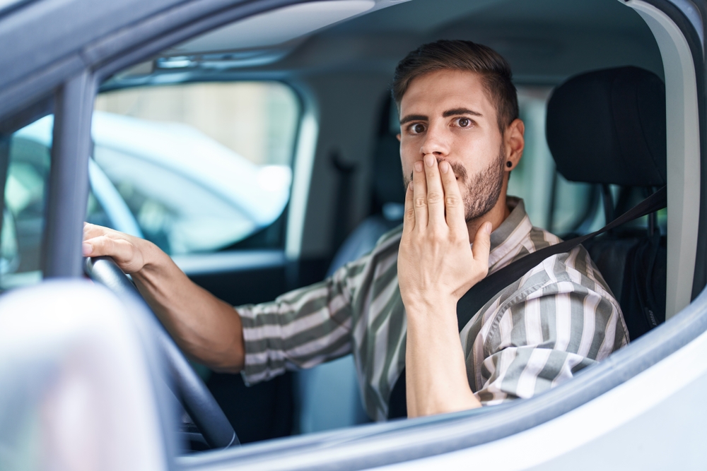 Shocked man in car looking at something