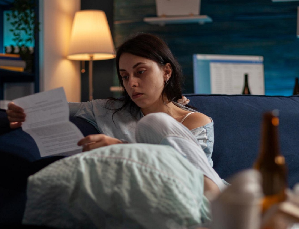Young woman is looking at eviction letter with sad face.
