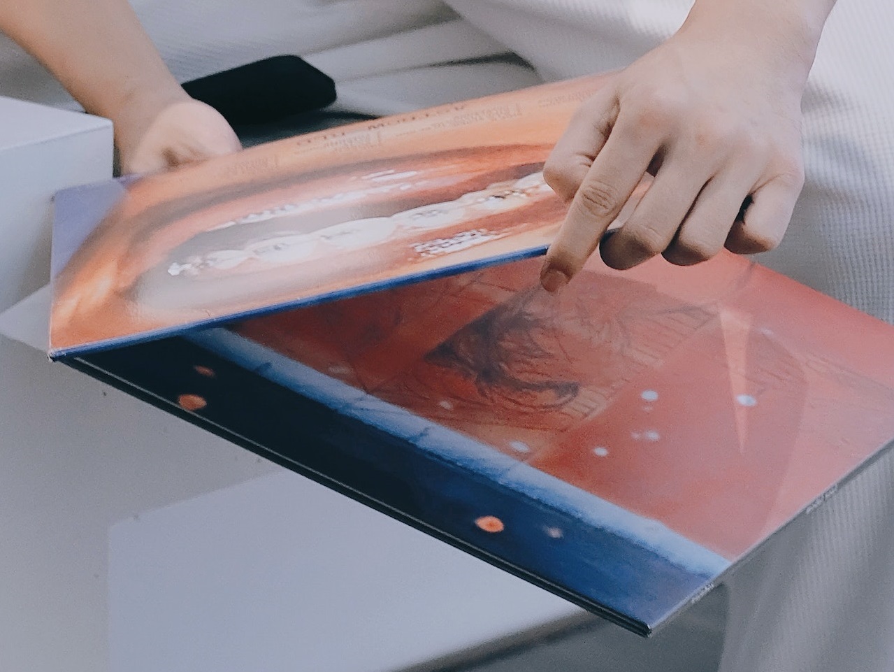 Man is holding a vinyl records.