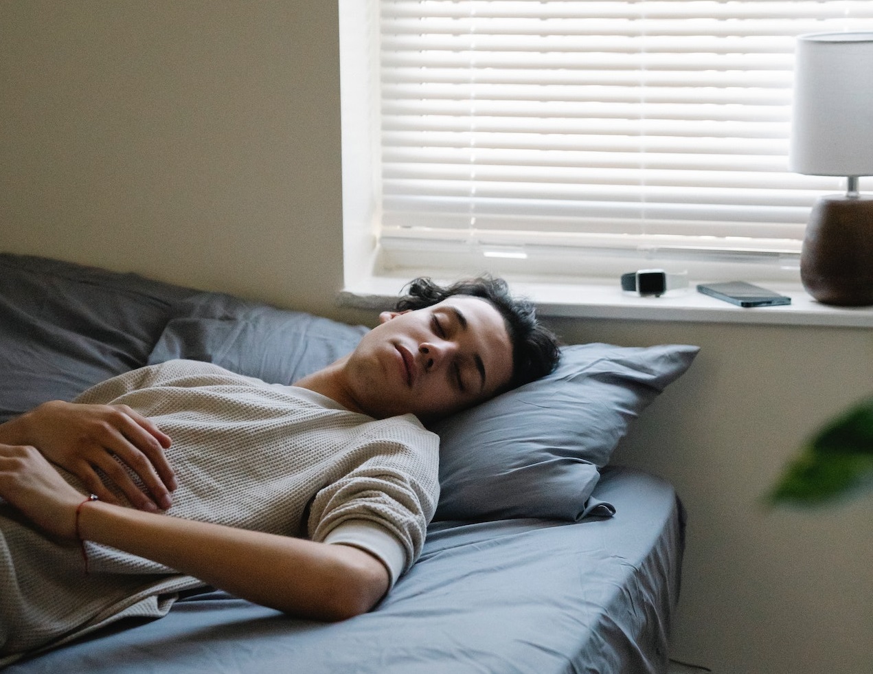 Young man is sleeping in the bed.