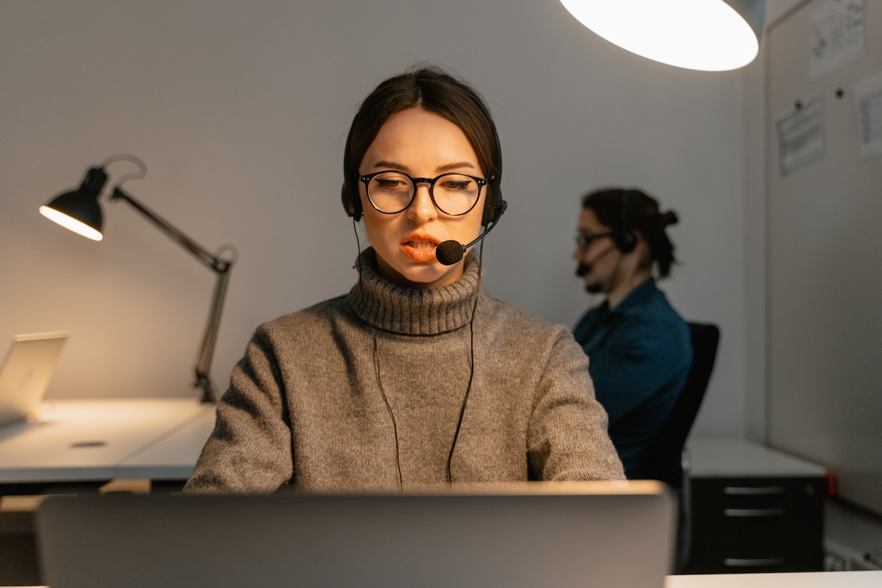 Young woman is talking on the phone at call center.