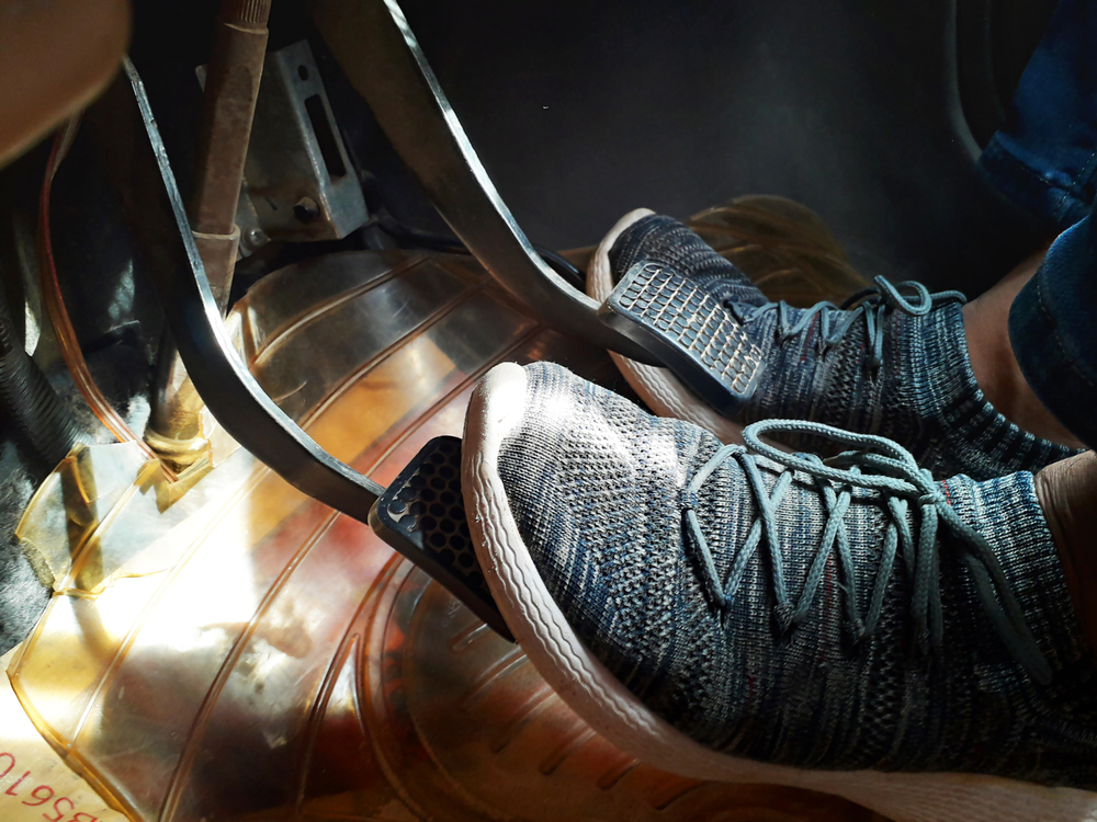 Feet on accelerator, brake and clutch in car