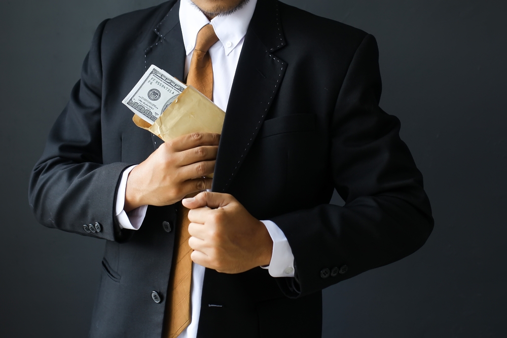 Man hiding fraud money in his pocket