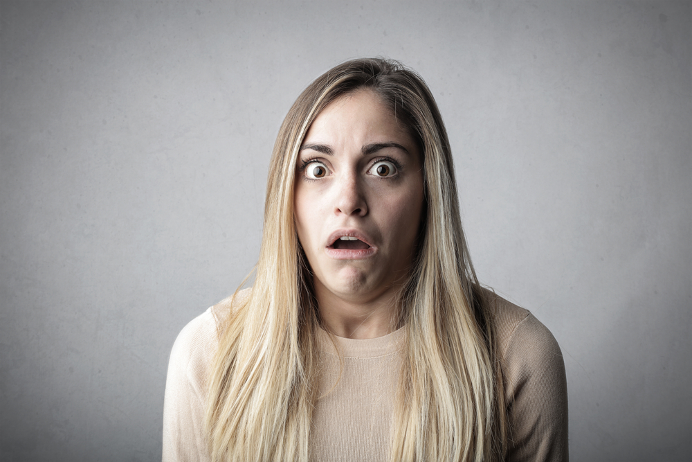 Shocked girl  looking at the camera with opened eyes