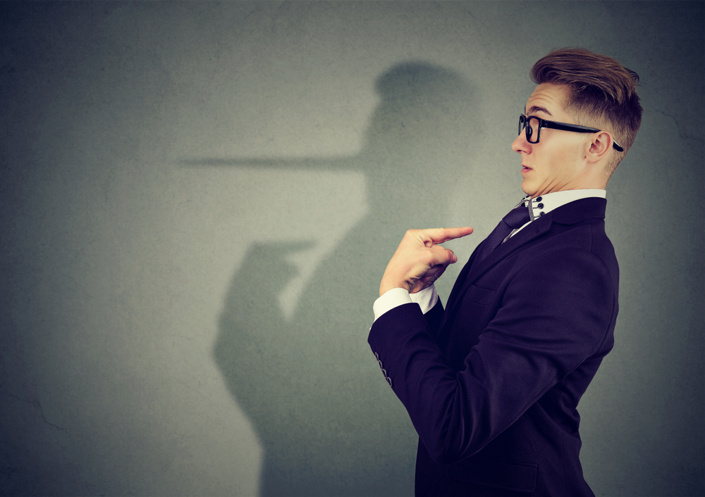 Side view of elegant man looking surprised when being caught on lie