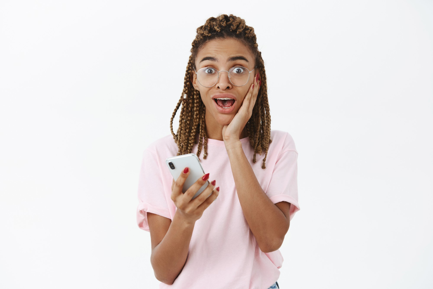 Young woman is looking surprised with phone on her hand.