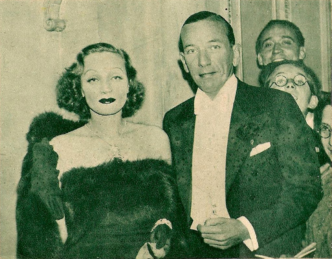 B&W photo of Marlene Dietrich and Noel Coward looking at front - 1936