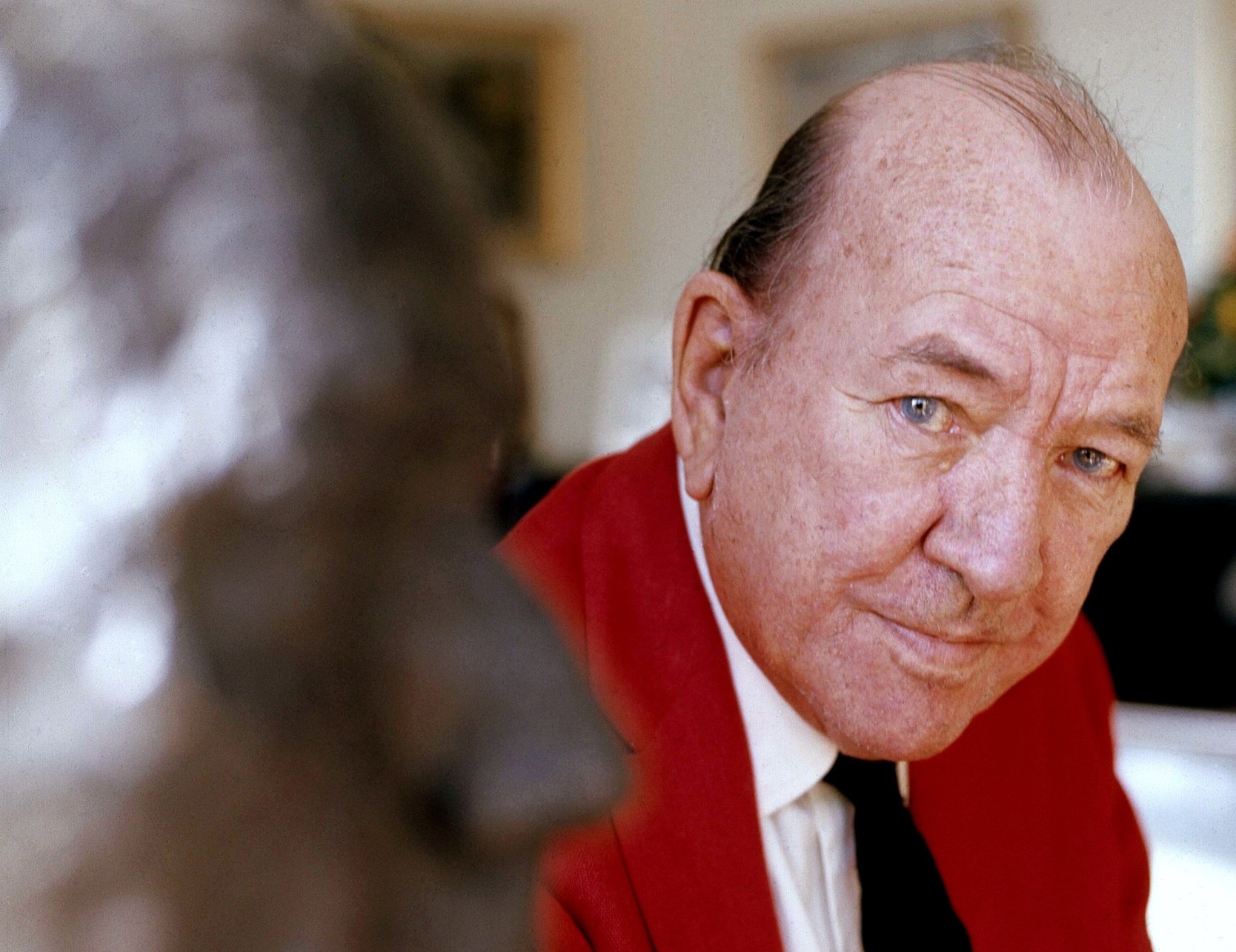 Photo of Noel Coward wearing red jacket is looking at camera - 1972