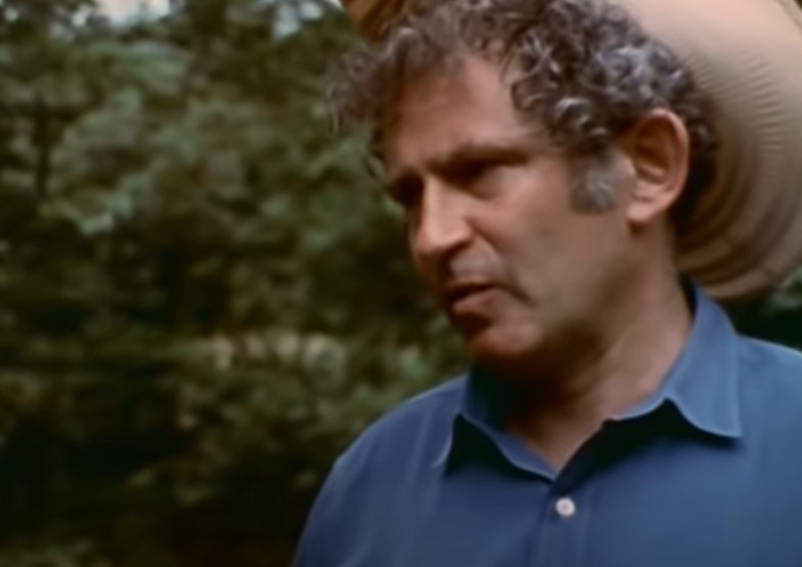 Maidstone 1970 Norman Mailer looking at someone in a park