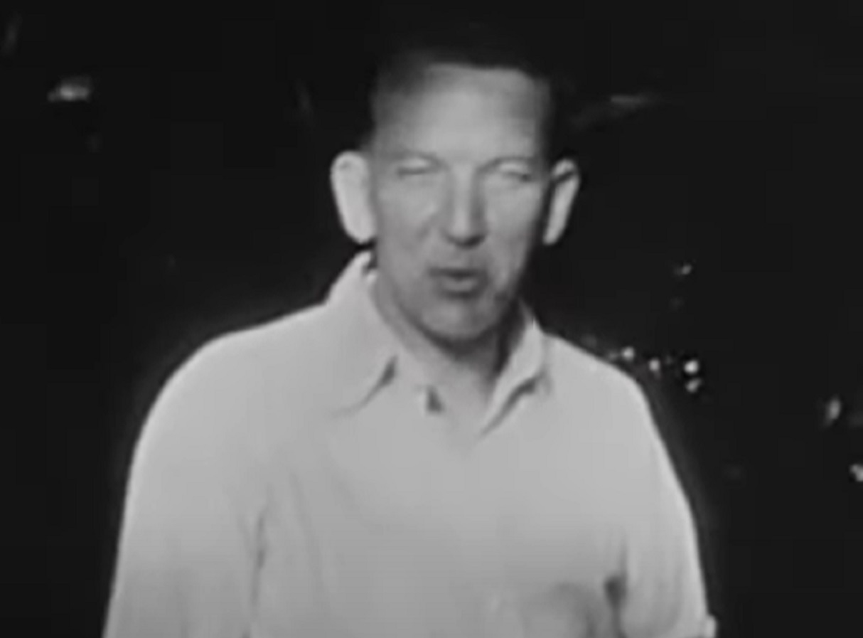 B&W Screenshot: Noel Coward wearing white shirt is looking at front - from Mad About the Boy: The Noel Coward Story (2023)