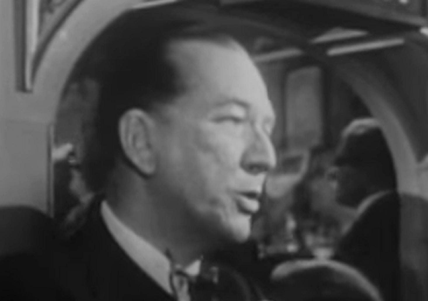 B&W Screenshot: Noel Coward is talking and looking at side - from Mad About the Boy: The Noel Coward Story (2023)