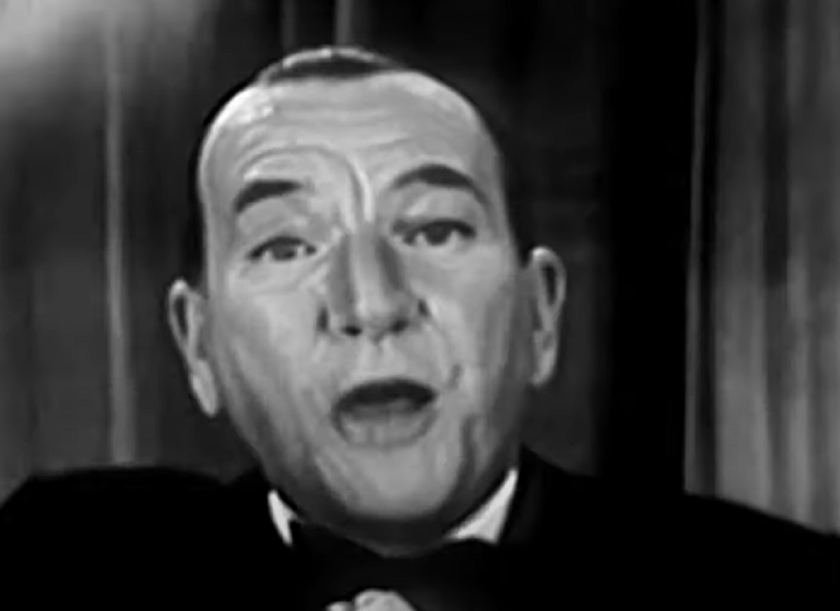 B&W Screenshot: Noel Coward is looking at camera with surprised face - from Mad About the Boy: The Noel Coward Story (2023)