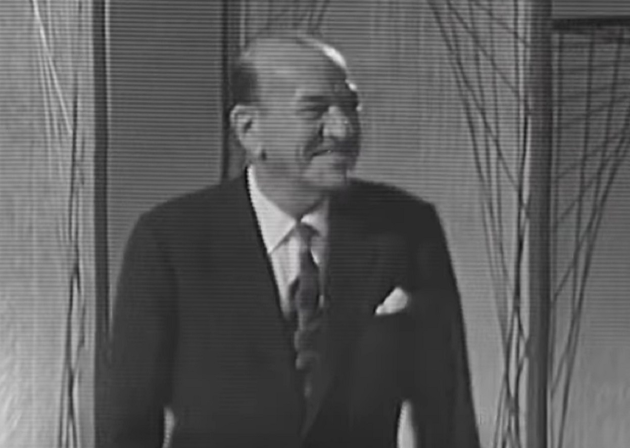 B&W Screenshot: Noel Coward is looking at side and smiling - from Mad About the Boy: The Noel Coward Story (2023)