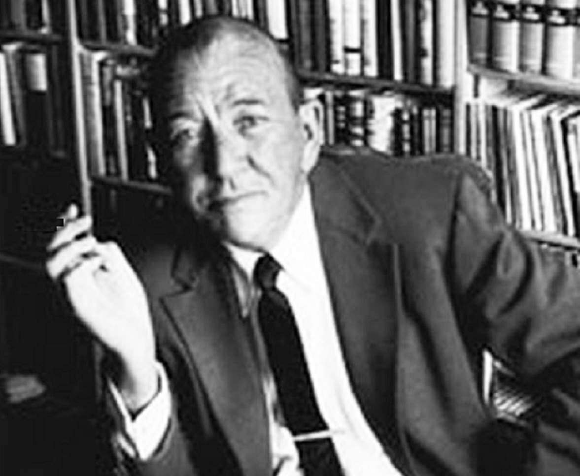 B&W photo of Noel Coward wearing black suit and tie is looking at front - 1963