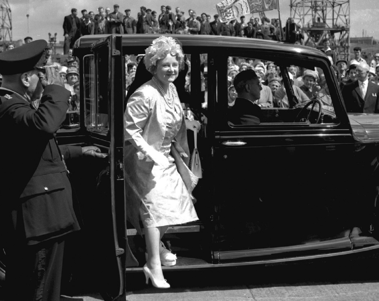 B&W photo of The Queen Mother arriving at Walker Naval Yard wearing white coat  - 1961