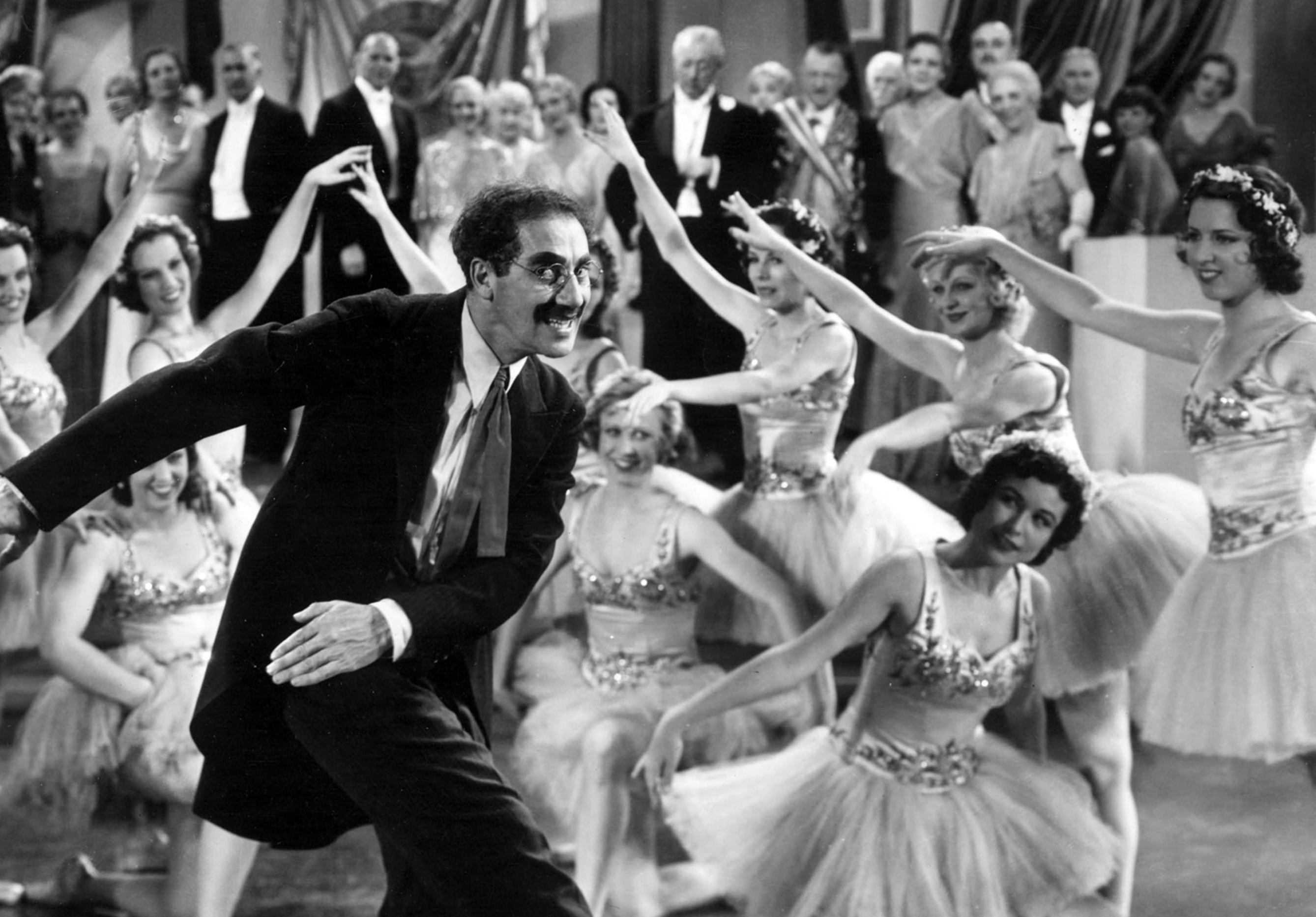 Black and white photo of Groucho Marks dancing
