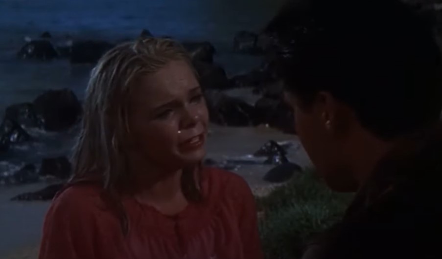 Jenny Maxwell in Blue Hawaii (1962) in pink top looking at the camera