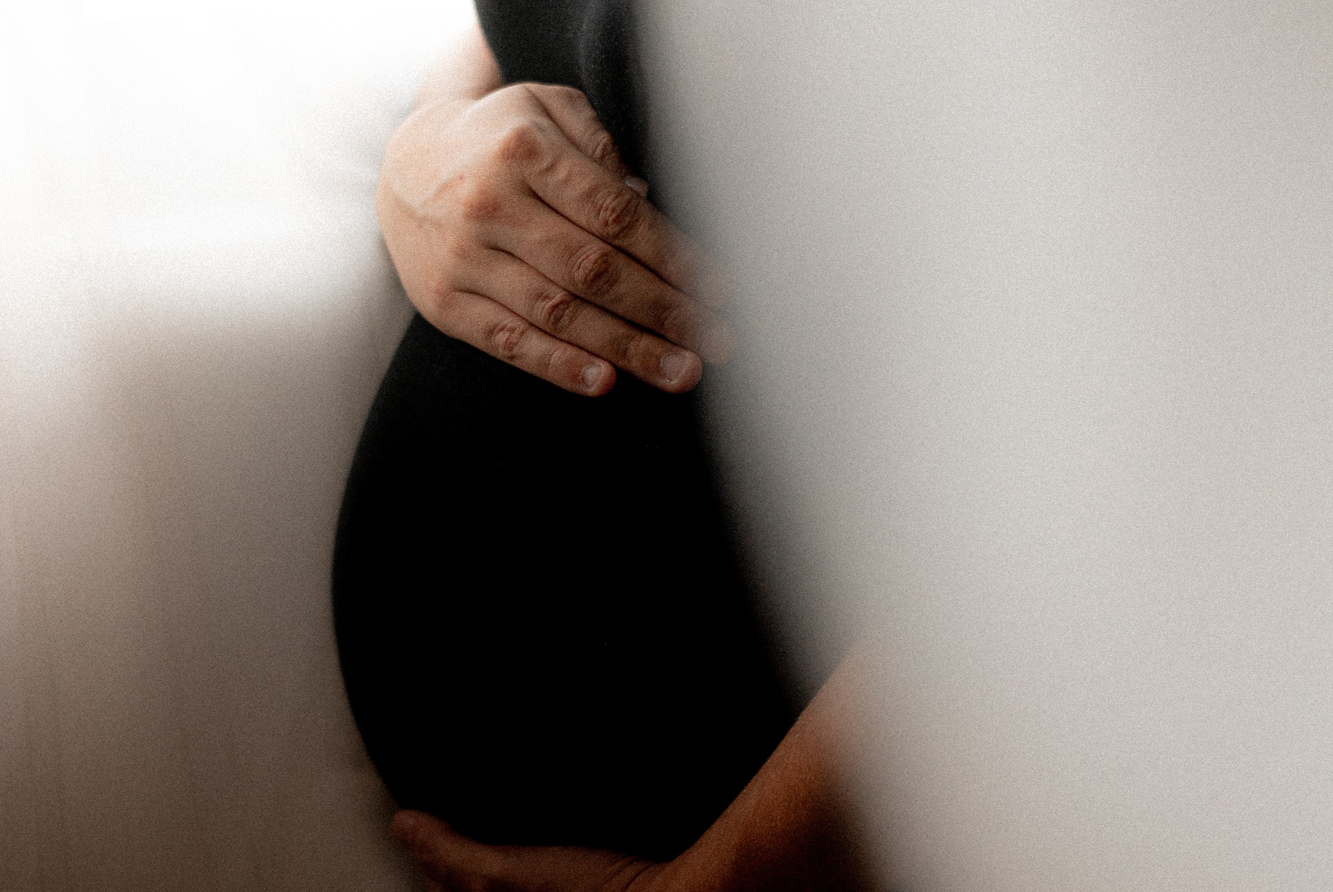 Woman holding her pregnant belly