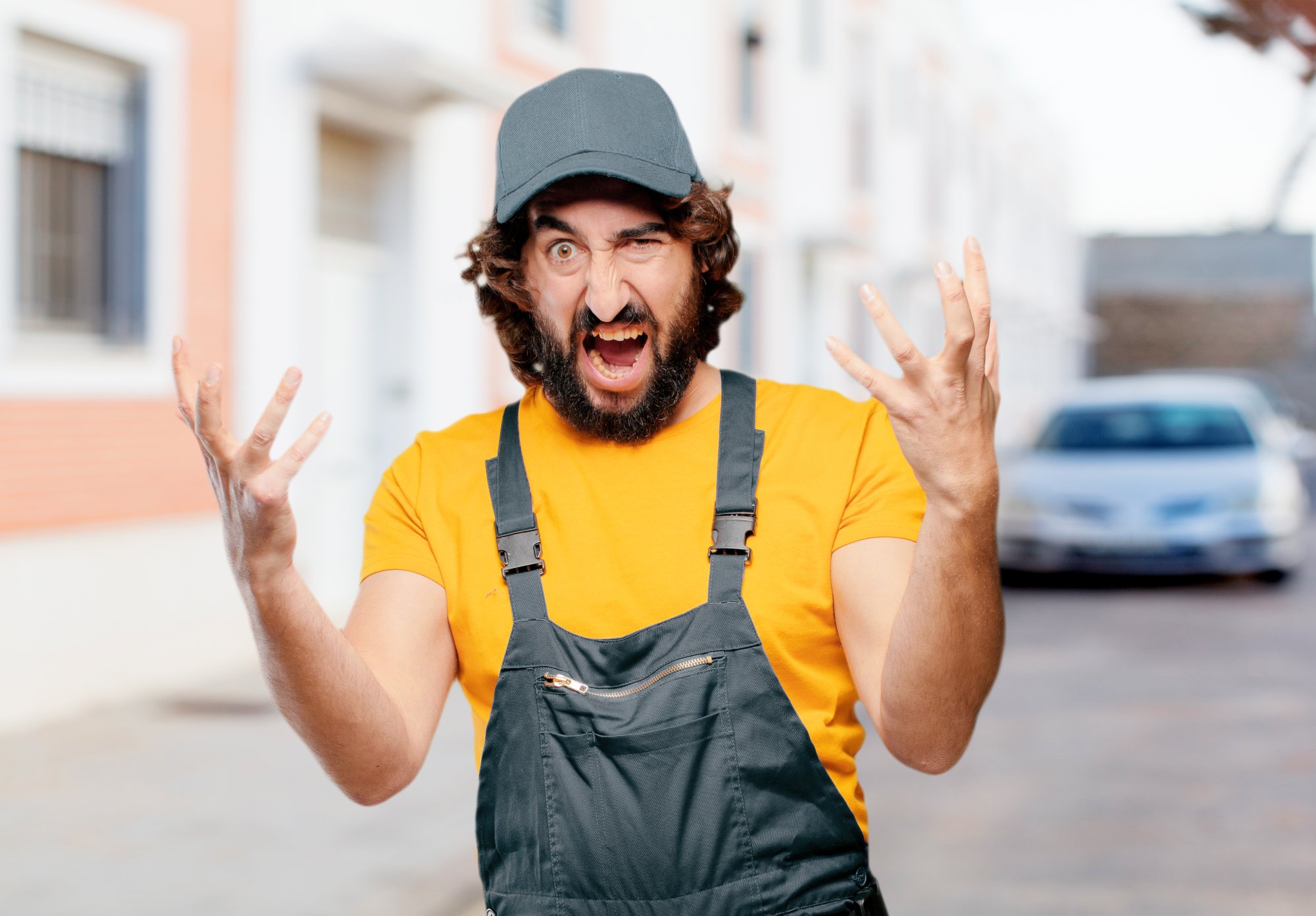 Angry employee with lifted hands yelling at the camera