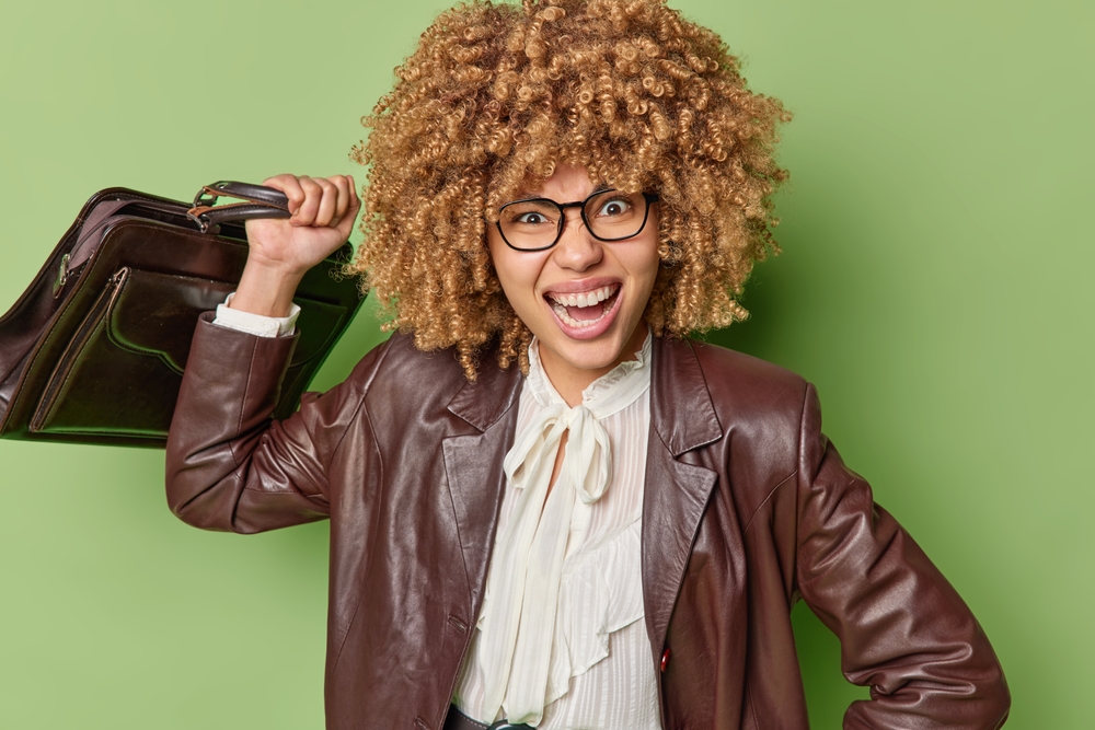 Annoyed female office worker screams at the camera