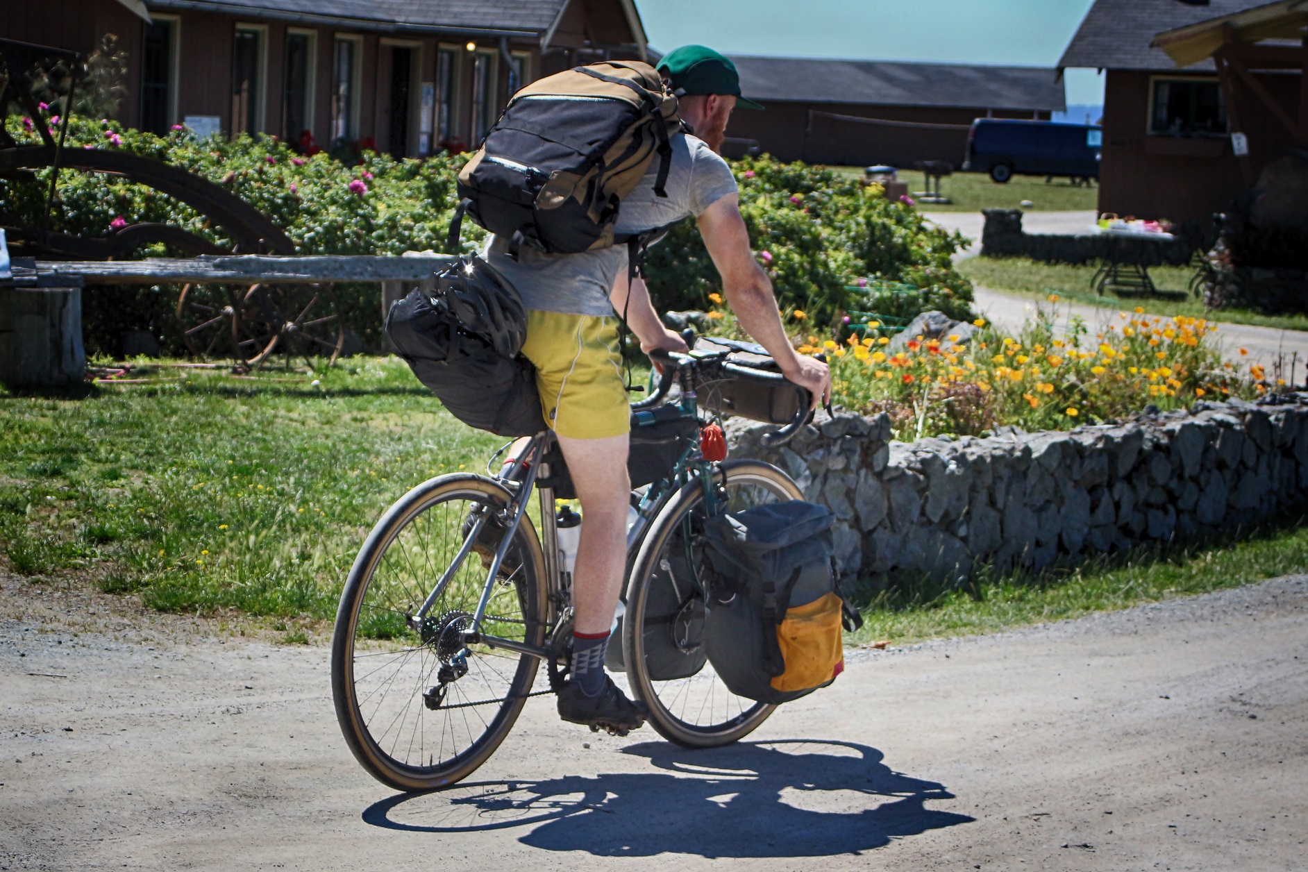 Bicycle traveler with all his camping gear heading out on his bike.