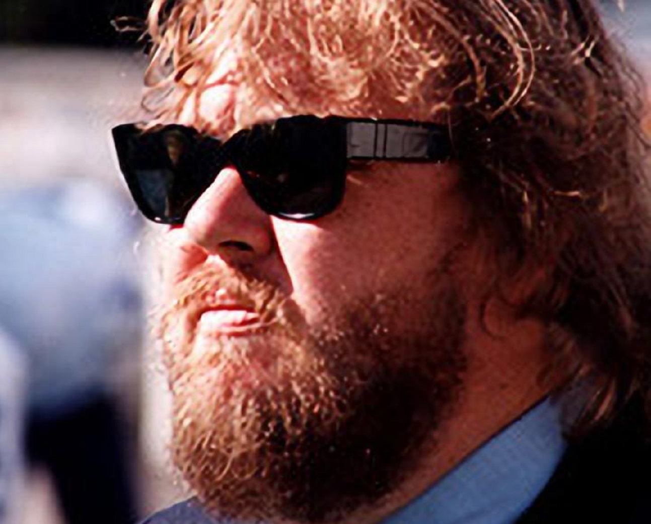 John Candy wearing black suit and black glasses is looking at front - 1993