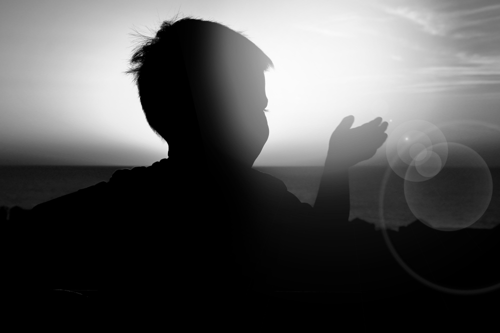 Child outside at sunset