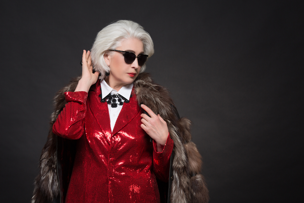 Beautiful old woman with blond hair wearing sunglasses