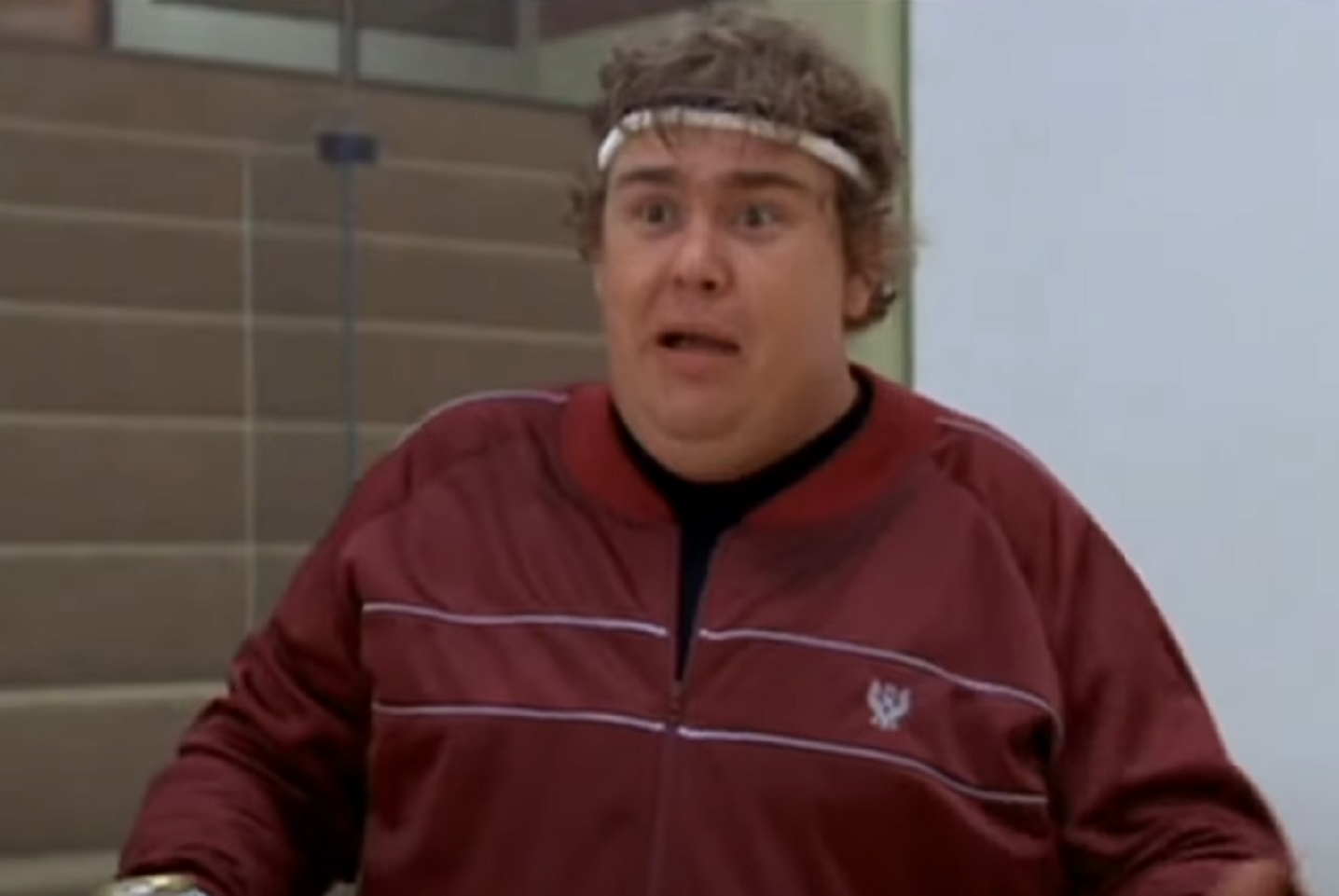 John Candy wearing red jacket is looking upset a side - from Splash (1984)