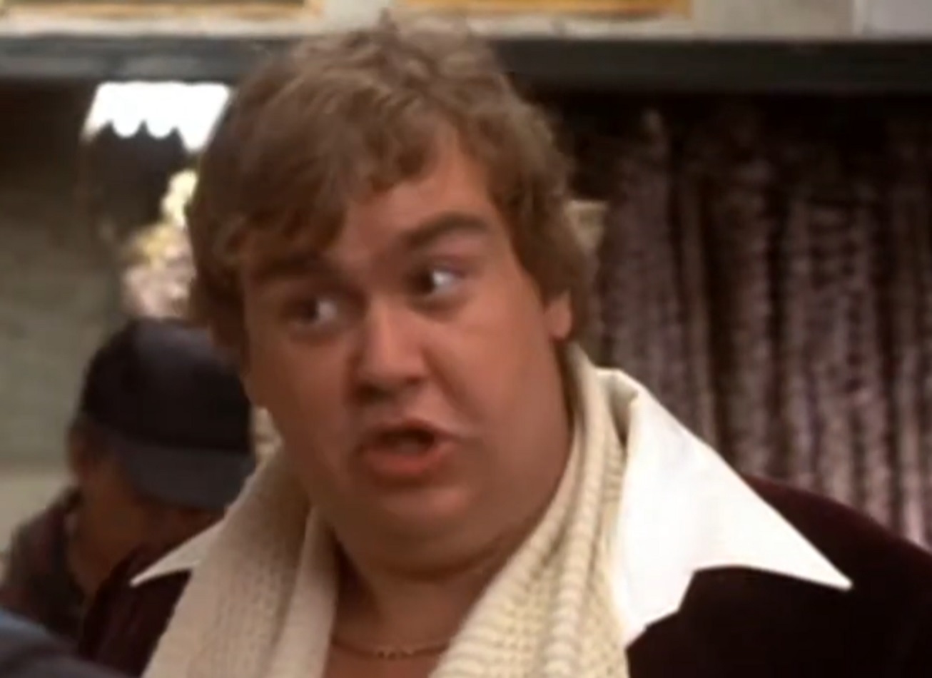 Screenshot :John Candy wearing white scarf is talking and looking at side - from Splash (1984)