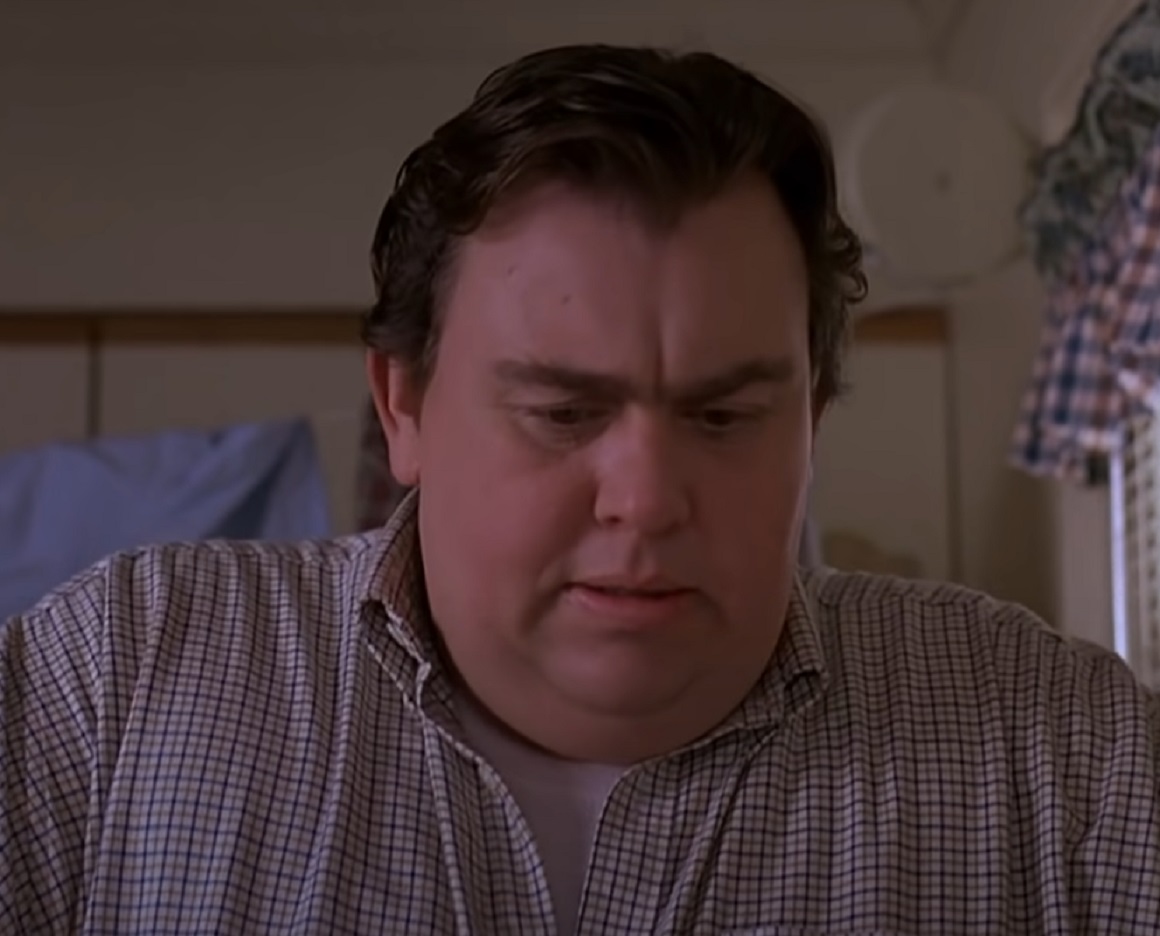 Screenshot :John Candy wearing beige shirt is looking down - from Uncle Buck (1989)